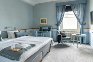 Ένα ή περισσότερα κρεβάτια σε δωμάτιο στο First Hotel Statt Örnsköldsvik