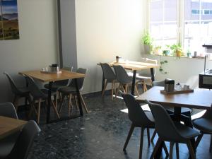 a row of tables and chairs in a restaurant at Birkeneck in Heusenstamm