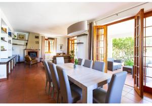 a dining room with a wooden table and chairs at Casa del Sole in Cinisi