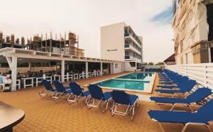 a deck with chairs and a swimming pool on a building at Lavender Villa in Mamaia Sat/Năvodari