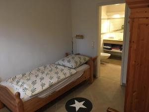 a bedroom with a bed and a bathroom at Ferienscheune Weenzen in Duingen