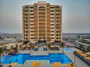 a large building with a pool of water in front of it at City Stay Beach Hotel Apartments - Marjan Island in Ras al Khaimah