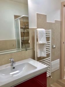 a bathroom with a sink and a mirror and a towel at Garda Sailor’s House in Garda +37 photos