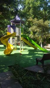 a playground with a slide in a park at Hotel Bulaq in Turist