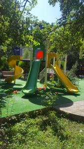 a playground with a slide in a park at Hotel Bulaq in Turist