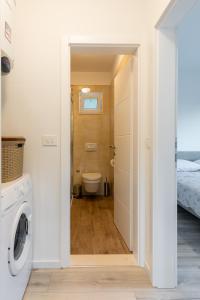 a bathroom with a washer and dryer in a room at Relax Zone Apartment in Trsteno