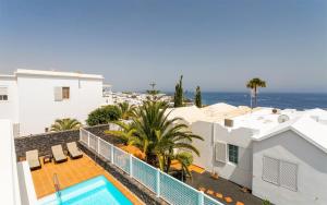 a view from the balcony of a house with a swimming pool at Villa Felicidad in Puerto del Carmen