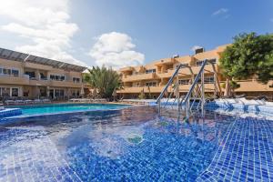 a swimming pool in front of a hotel at Hotel Arena Suite in Corralejo