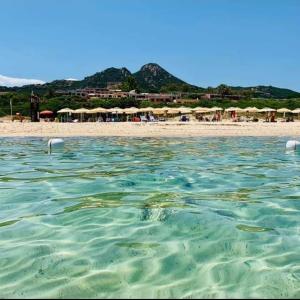 a view of a beach with umbrellas and the water at Free Beach Holiday Home in Monte Nai