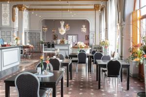 a restaurant with tables and chairs in a room at First Hotel Statt Örnsköldsvik in Örnsköldsvik