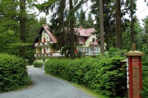 a house in the middle of a forest at Hotel Barbara in Warmensteinach