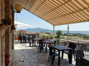 a row of tables and chairs on a patio at Albergo La Torre in Radicofani
