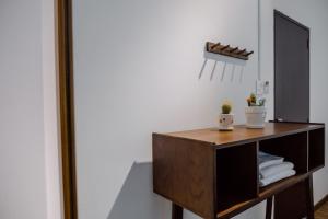 a dressing table in a room with a mirror at Laé Hostel in Tuy Hoa