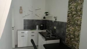 a small kitchen with a sink and a stove at City Apartments Ebern in Ebern +10 photos