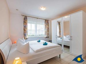 Ein Bett oder Betten in einem Zimmer der Unterkunft Ferienwohnung (-haus) Whg. 01 Gartenstraße