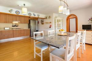 a kitchen with a dining room table and chairs at Villa Can Raco Ibiza in Sant Rafael de Sa Creu