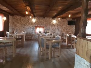 a restaurant with tables and chairs in a room at Plitvice Antico in Gornji Babin Potok