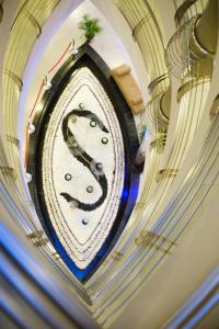 a clock hanging on a wall in a building at Signature Hotel Apartments and Spa in Dubai