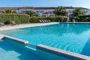 a large swimming pool with blue water at Thalacap Île de Ré - Thalasso & Spa in Ars-en-Ré