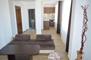 a living room with a couch and a table at SummerHouse Lozenets in Lozenets