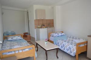 a small room with two beds and a table at Villa Marija in Ohrid
