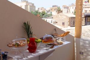 a table with food and drinks on a balcony at Agrigentumbreakfast in Agrigento