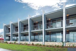 
a large white building with a large window at Aurora Ozone Hotel Kangaroo Island in Kingscote
