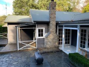 a garage with a door open on a house at Warby Weekender in Warburton