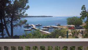 a view of a harbor with boats in the water at Apartmani Slavica in Rab