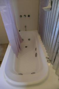 a white bath tub in a bathroom with a shower at Casas Chaura in El Bolsón +34 photos