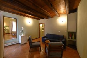 a living room with a blue couch and chairs at Osteria Luxury Apartments in Peschiera del Garda