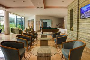 a lobby with tables and chairs and a pool table at Pestana Alvor Park Suites Hotel in Alvor