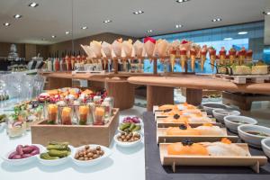 a buffet with many different types of food on display at Melia Sitges in Sitges