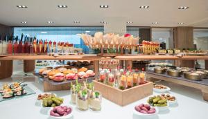 a buffet with many different types of food on display at Melia Sitges in Sitges