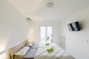 a bedroom with a large bed with two yellow pillows at Villa Sarah in Klimno