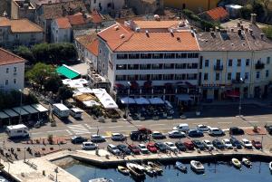 an aerial view of a city with cars parked in a parking lot at Apartment JELENA in Senj