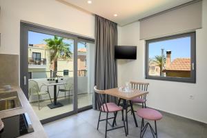 a kitchen and dining room with a table and chairs at Athina Suites Luxury Suites Near The Sea Platanias in Platanias