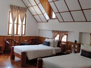 מיטה או מיטות בחדר ב-Hillock Villa