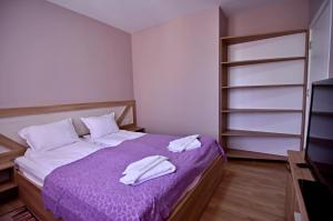 A bed or beds in a room at City Apartments