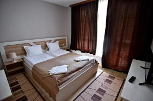 A bed or beds in a room at City Apartments
