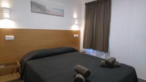 a bedroom with a bed with two towels on it at Bayside Salgados in Albufeira +37 photos