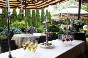 a table with glasses of wine and food on it at Hotel Dona in Kaliningrad