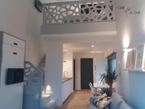 a living room with a blue couch and a kitchen at APARTAMENTOS VALLE DE IROLA in Luanco