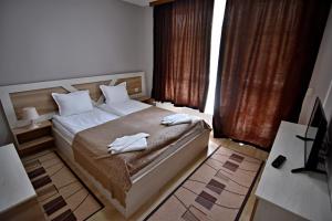 A bed or beds in a room at City Apartments