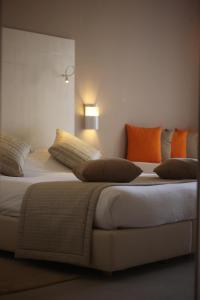 a hotel room with two beds and two lamps at Seabel Rym Beach Djerba in Taguermess