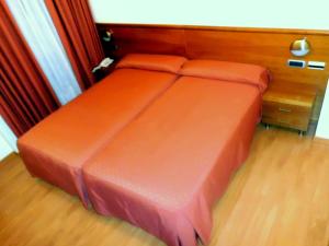 A bed or beds in a room at Hotel Vila do Alba