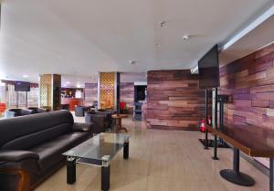 a living room with a couch and a piano at Khobar Palace Hotel in Al Khobar