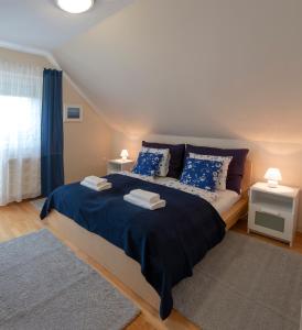 a bedroom with a large bed and a large window at Airport Apartman in Vecsés