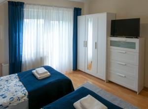 A bed or beds in a room at Airport Apartman