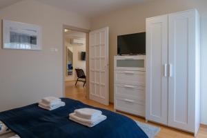 A bed or beds in a room at Airport Apartman